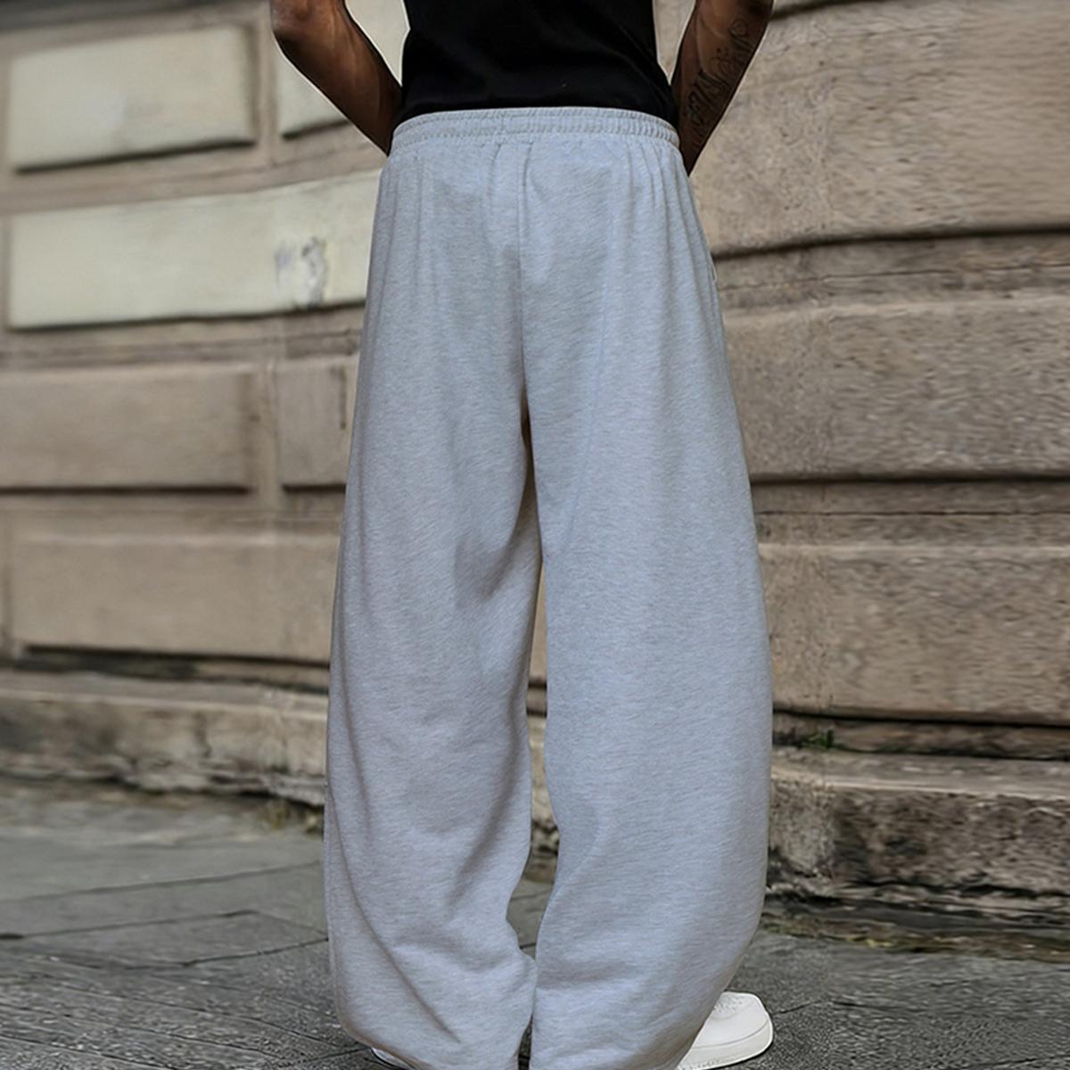 Men's solid color casual pants with an adjustable drawstring waistband. Stylish yet casual, comfortable and versatile, loose fit, suitable for all seasons, combining streetwear and sporty style