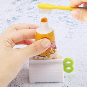 A set of 4 toothpaste tube rollers - manual squeeze tool, toothbrush squeezer, clip holder/winder, colors random.