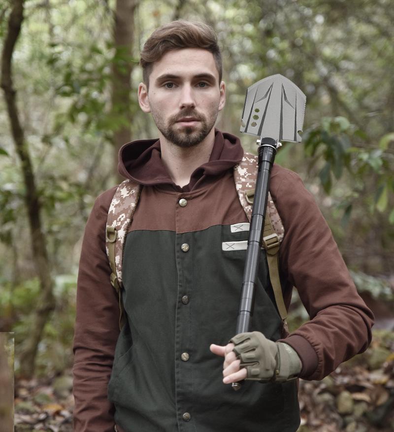 Multifunctional folding shovel, a camping survival tool, equipped with a flint fire starter, suitable for hiking, hunting, fishing, and other outdoor activities