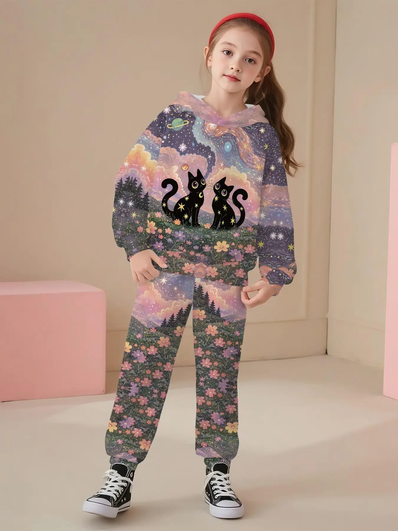 Two-piece set consisting of a girls' hooded sweatshirt and long pants. It features an all-over hand-drawn print of two black cats among mountain wild flowers against a Van Gogh-style nebula flower sea. This forest-style romantic children’s outfit adopts d