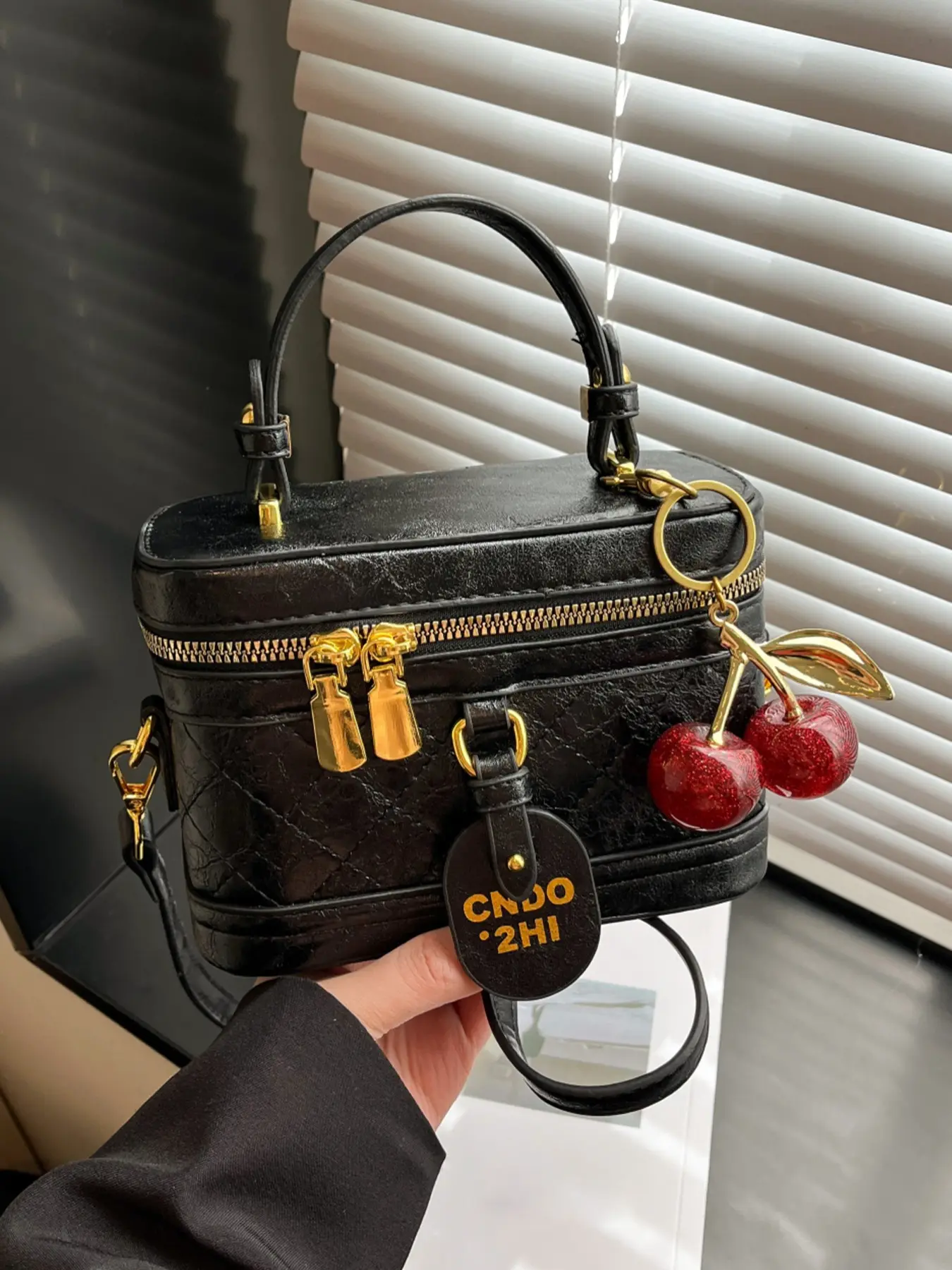 Stylish retro mini box‑shaped vanity handbag with decorative cherry charm, top handle and detachable crossbody shoulder strap. A versatile accessory ideal for brunch dates, night parties and casual daily outfits Zippered handbag