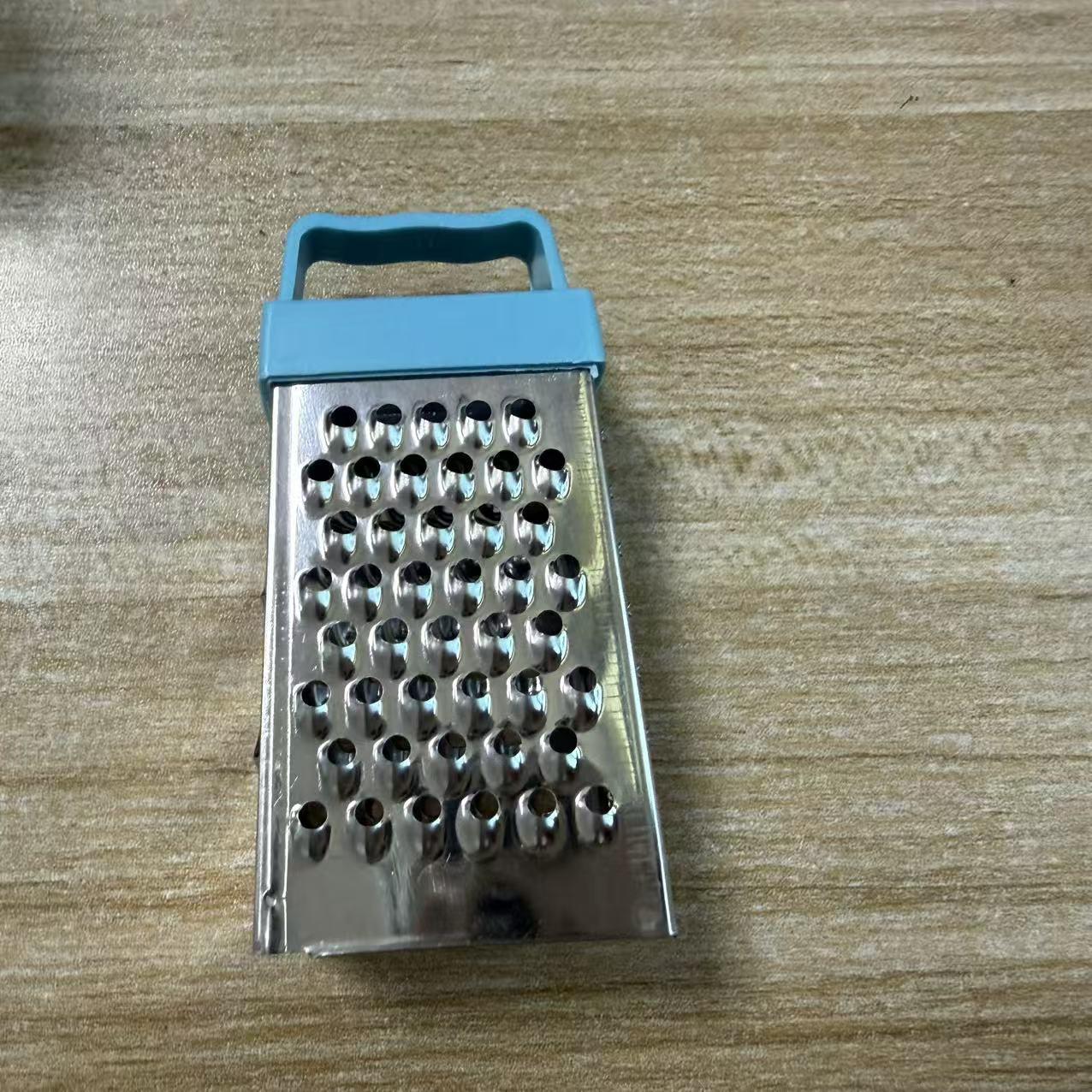 Multifunctional stainless steel household tool for peeling garlic, slicing vegetables and fruits, and shredding potatoes