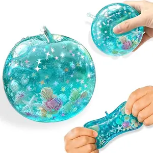 Apple soft rubber squeeze toy, blue ocean island style pressure reducing ball with glitter, slow rebound desktop display Apple soft rubber toy, transparent blue with star glitter effect, suitable for various holiday gifts