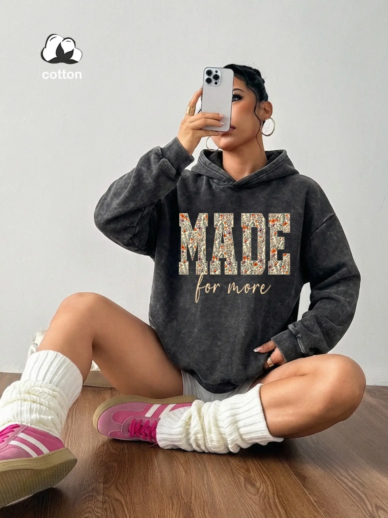 A relaxed, oversized hoodie featuring a washed finish and floral prints with Spanish phrases on both the front and back—perfect for casual coffee shop visits or everyday city commuting.