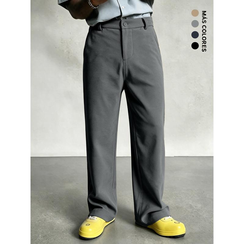 Relaxed wide-leg men's casual trousers with classic button waist design, smooth vertical textured fabric, clean tailored silhouette, versatile daily bottom piece to elevate minimalist modern mensfashion styling.