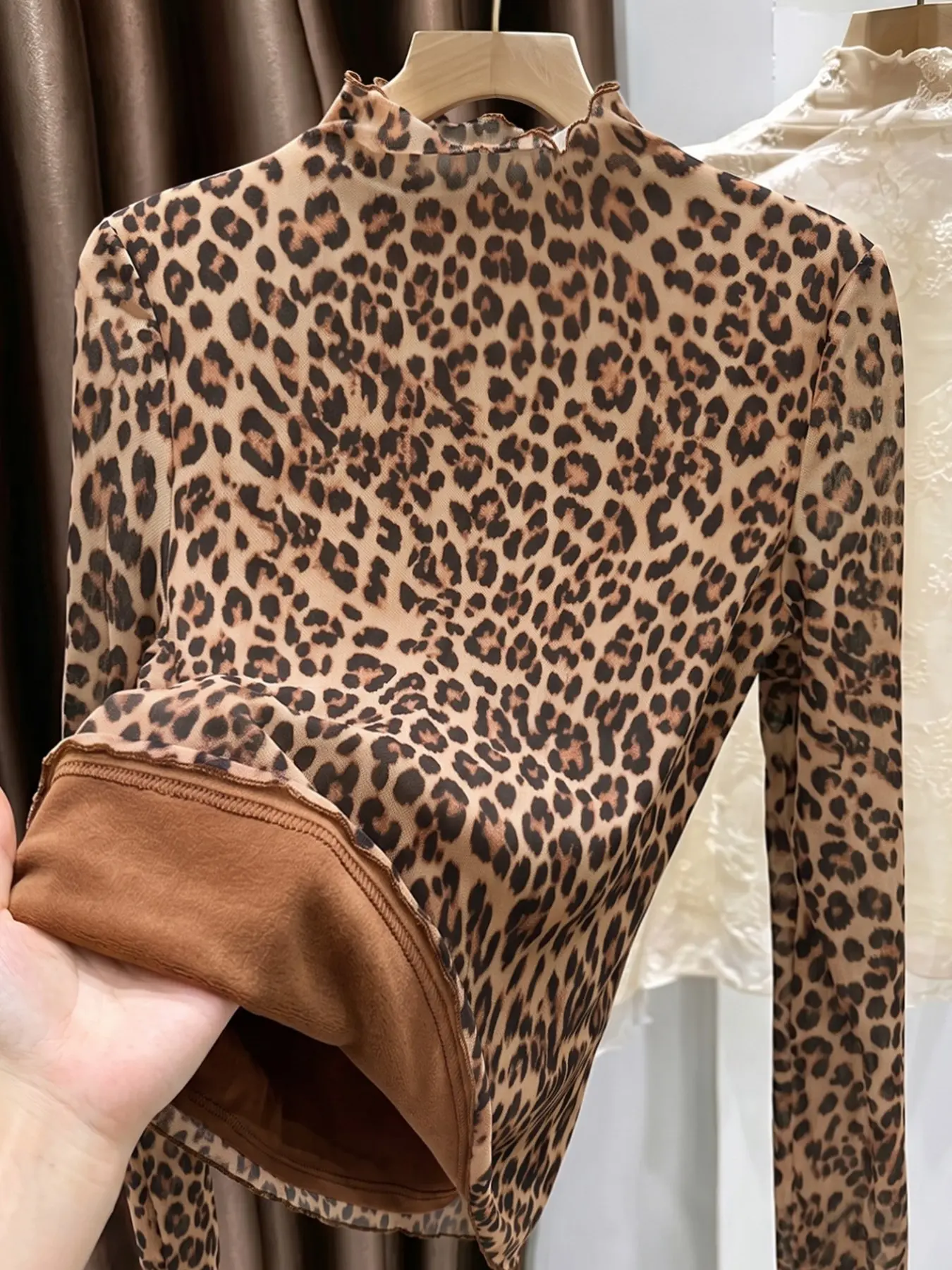 Women's fleece-lined leopard print top: a form-fitting, warm base layer featuring a high neck and long sleeves.