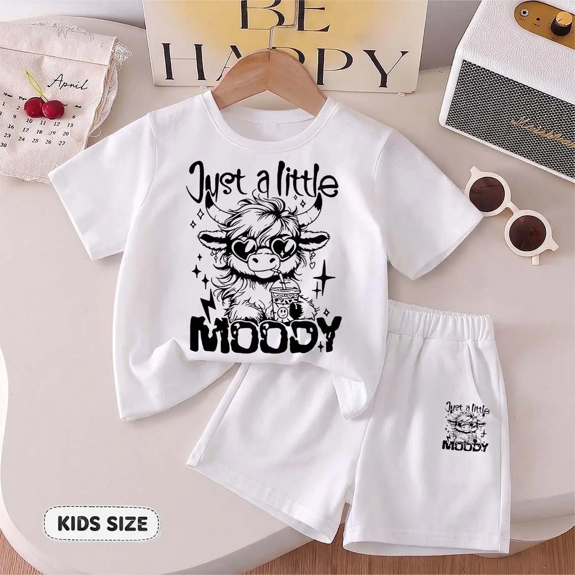 Kids’ “Just a Little Moody” Cartoon Print Short-Sleeve T-Shirt And Shorts Set—Casual Summer Kids' Clothing. This Round-Neck Outfit Combination Is Perfect For Everyday Wear And Outdoor Play.