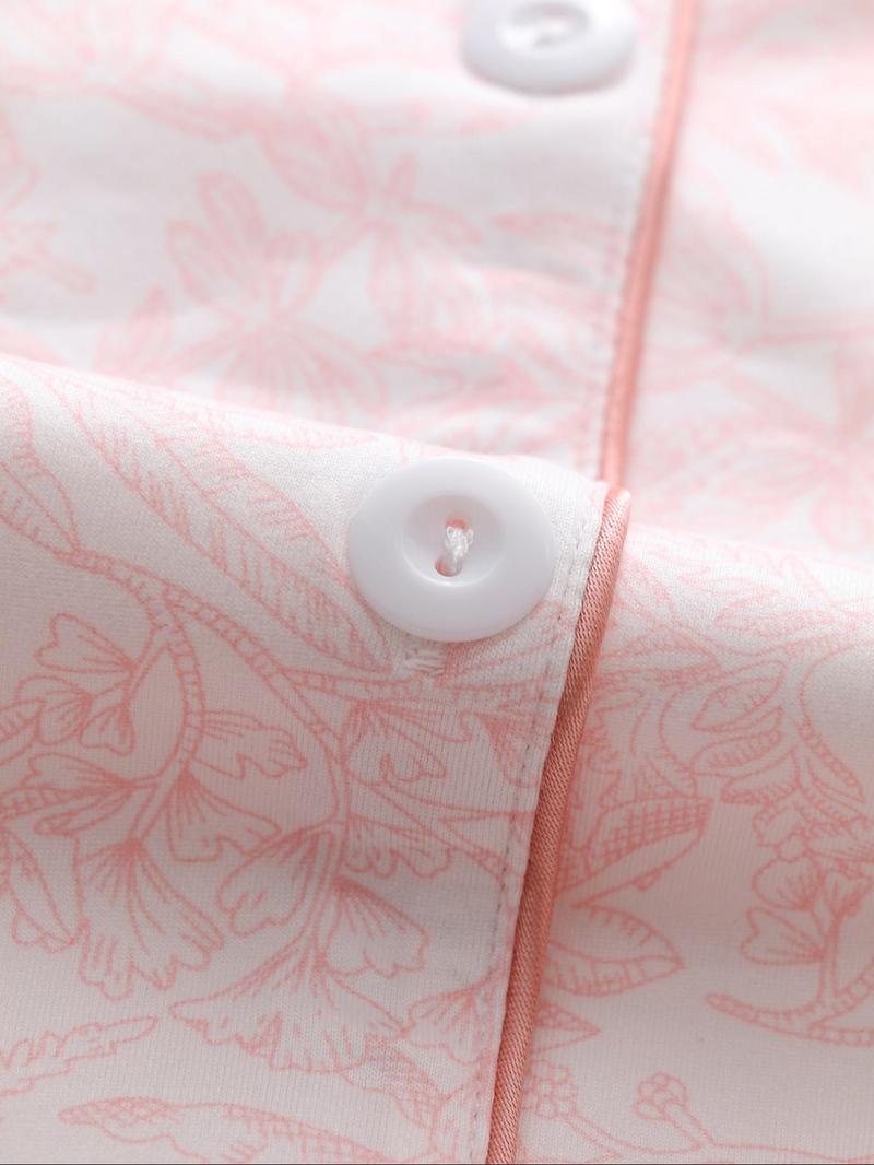 Two-piece pink ladies' pajama set with full-color prints. Button-front collar shirt and elastic waist pants pajama. Casual and comfortable collar long-sleeved top and long pants pajama set. Ladies' pajamas for spring and autumn.