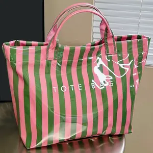 Stripe color-block waterproof PVC handbag with glossy finish. Roomy space for makeup and toiletries, versatile for outdoor travel and students’ daily wash storage.