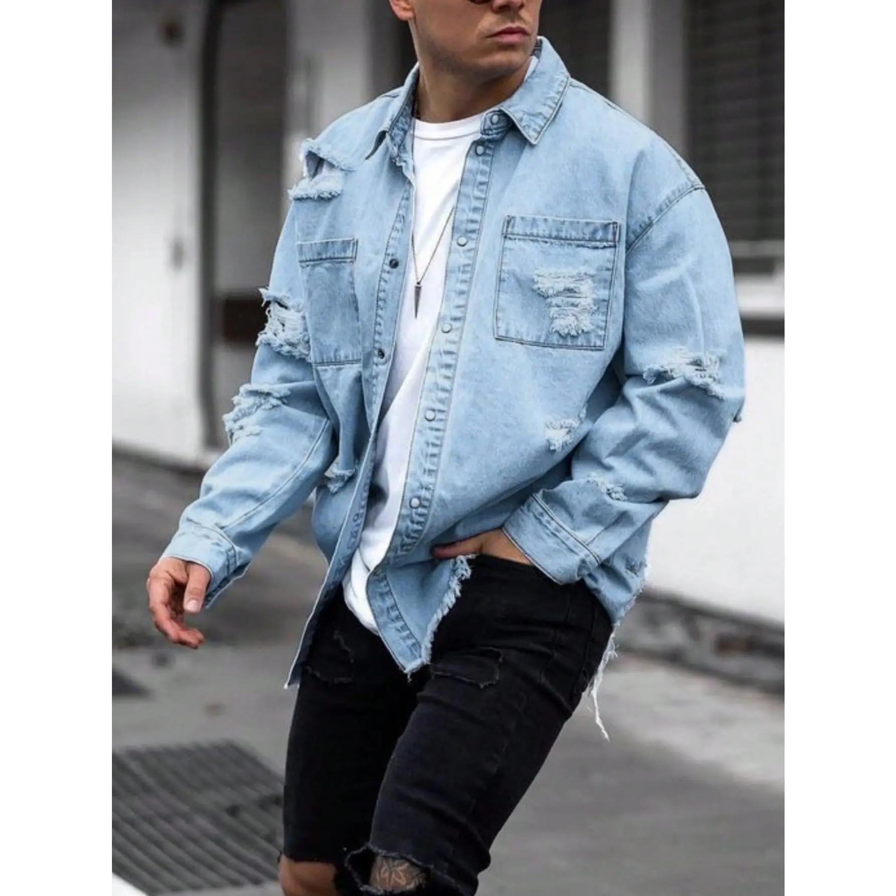 Cotton denim shirt jacket featuring distressed ripped details, chest patch pockets and classic lapel collar. Loose oversized silhouette delivers streetwear vibes, an eye-catching outerwear choice for modern mensfashion daily styling.