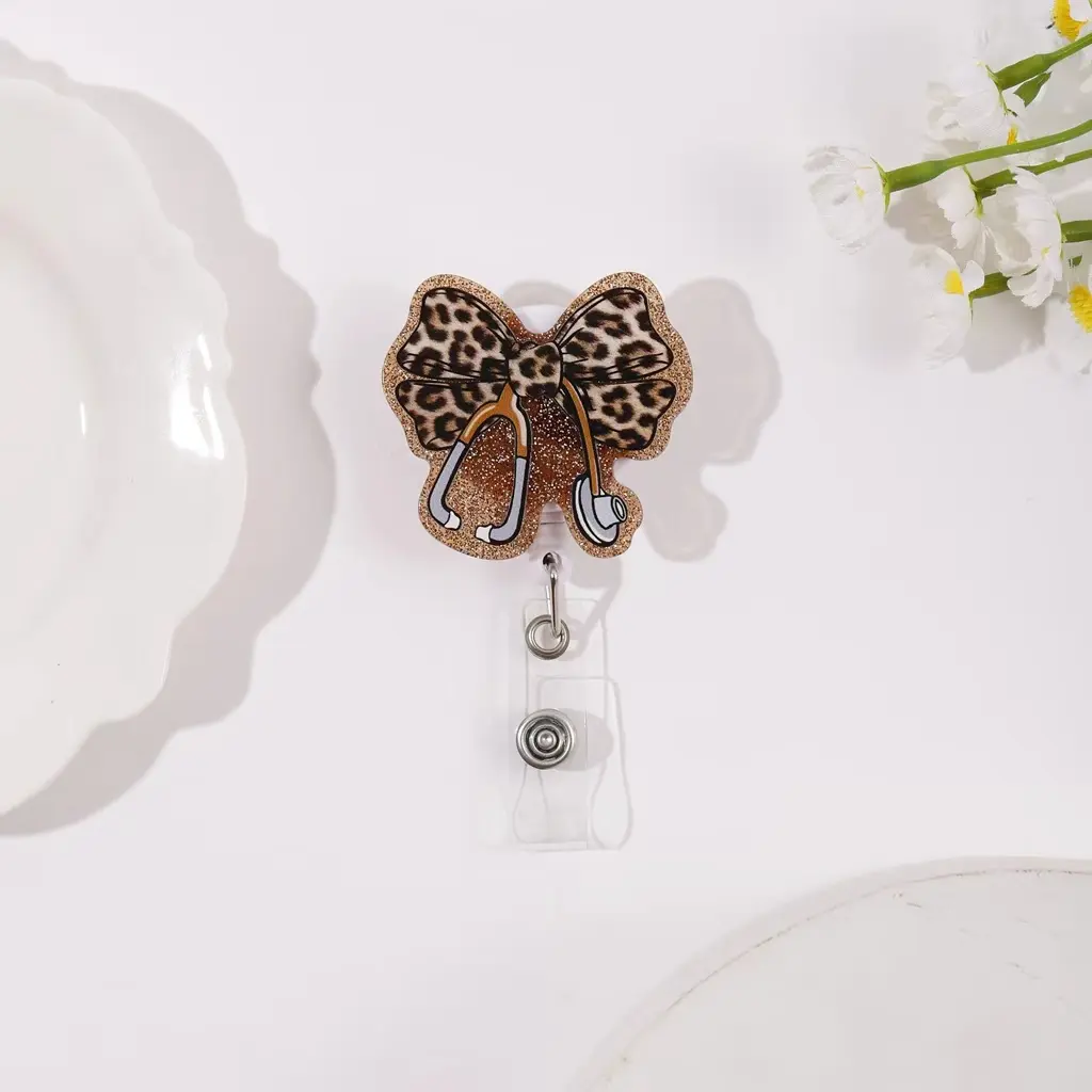 Adjustable lanyard with a leopard-print bow design and a clear ID card holder; ideal for nurses and doctors; features a stethoscope-shaped clip