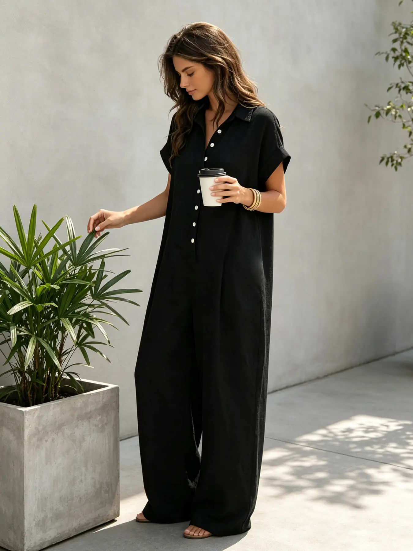 A lady's fashion casual French lazy-fit jumpsuit with a loose button-up design, featuring slimming wide-leg style. Perfect for summer, suitable for light social occasions, afternoon tea, vacation trips, commuting, and at-home wear. Button Front Jumpsuit