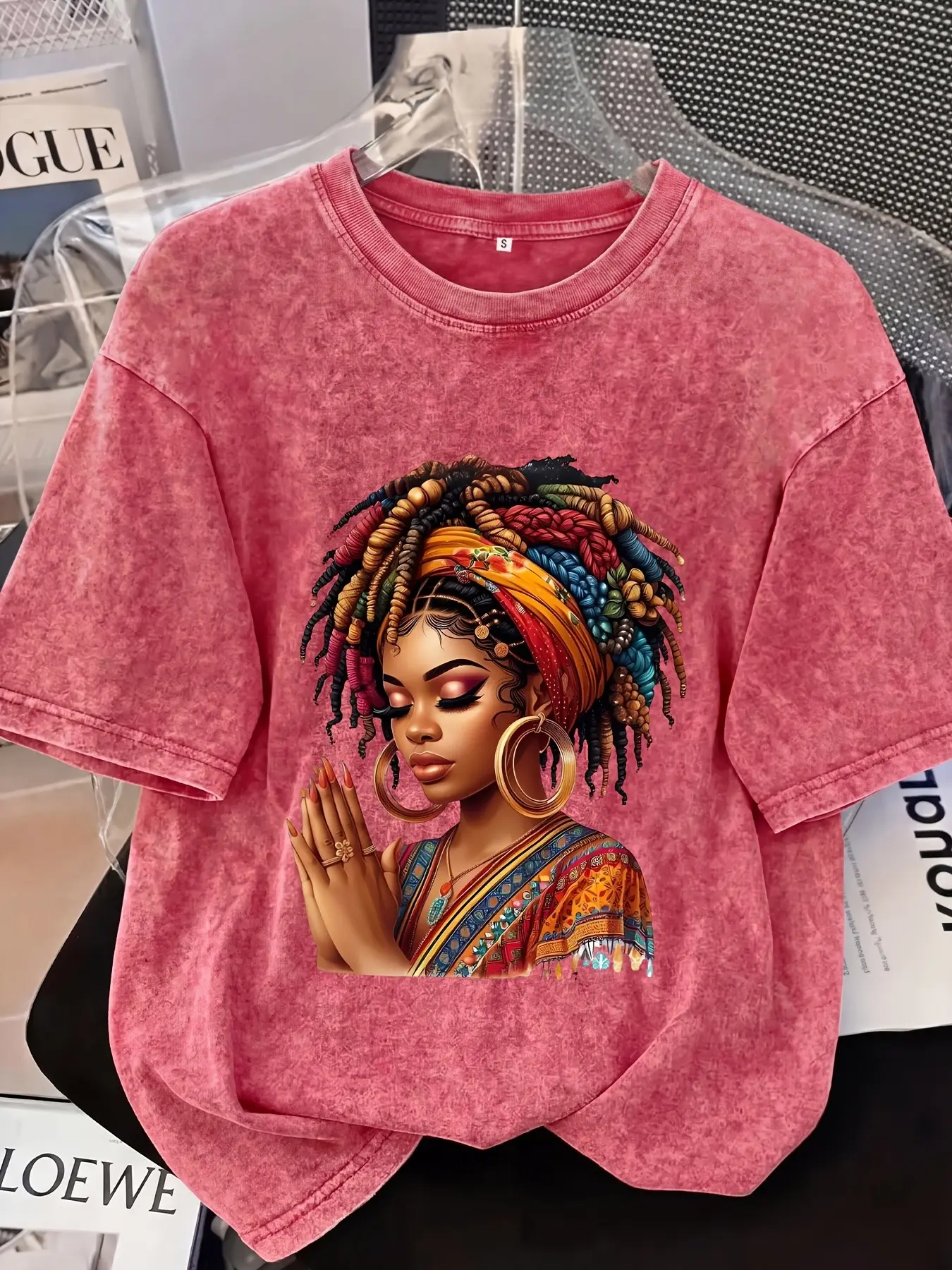 Distressed T-shirt featuring a colorful portrait print of an African woman; relaxed American style with soft, vintage-wash fabric—perfect for pairing with denim shorts or wide-leg trousers for a casual street-style look Streetwear.