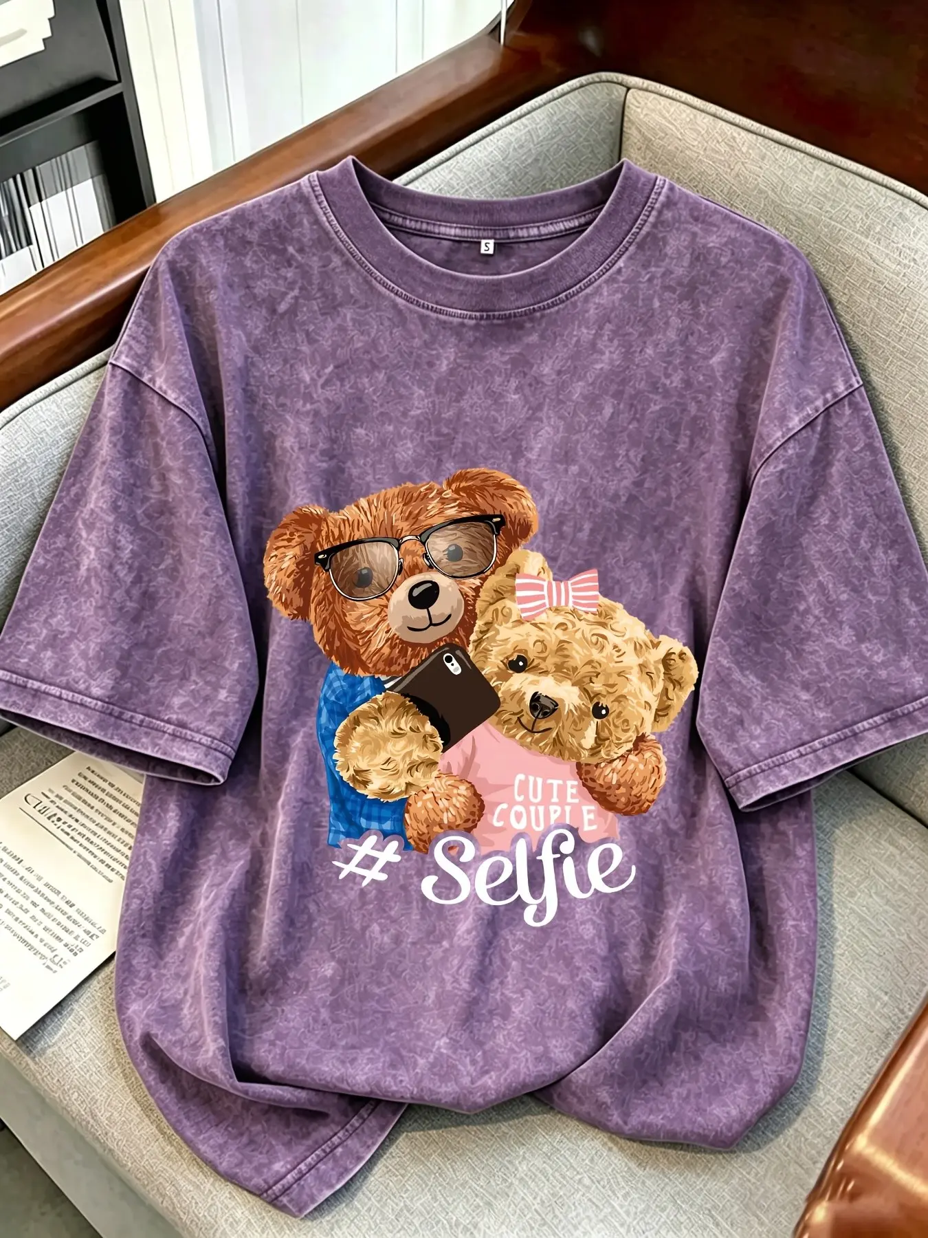 Y2K-style washed, distressed basic short-sleeve T-shirt featuring a cute "selfie-taking bear" graphic; American retro "It Girl" aesthetic Vibe; versatile and flattering for all body types; perfect for daily commuting or casual street style; Streetwear