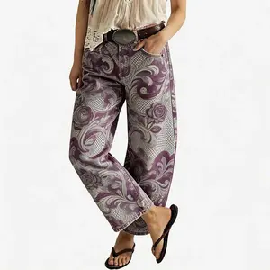 Women's vintage-wash wide-leg jeans; Y2K-style loose-fitting trousers; soft pink base with a bohemian floral print; suitable for year-round outdoor activities and streetwear styling.