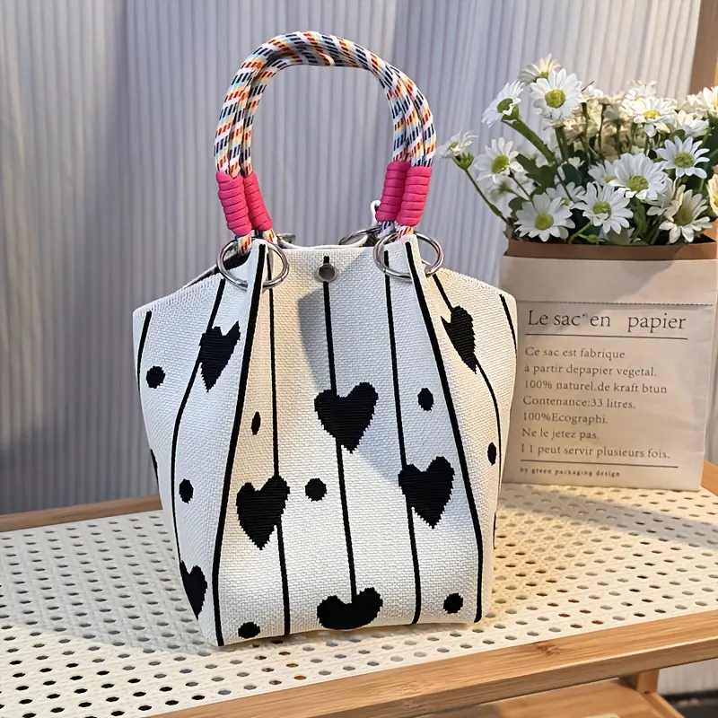 A cute, large-capacity black bag with a knot detail—an elegant, versatile travel handbag featuring a detachable shoulder strap.