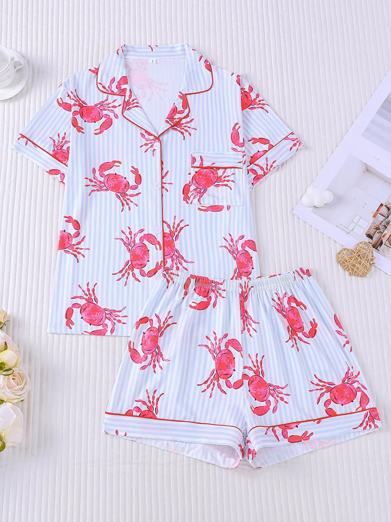 Women's 2-piece pajama set, light blue white vertical stripes with hand-drawn red crab prints, fresh ocean vacation style. Red piping lapel top with pocket, elastic waist shorts, soft comfy all-season casual loungewear for women