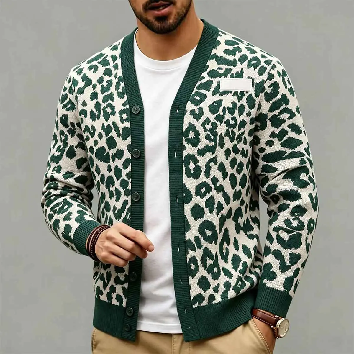 Men's fashionable green leopard print V-neck knitted cardigan, with a creamy base and dark green spotted pattern. The collar, cuffs, and hem are decorated with pure green ribbed edges, and the front is a button style long sleeved knitted jacket. It is a s