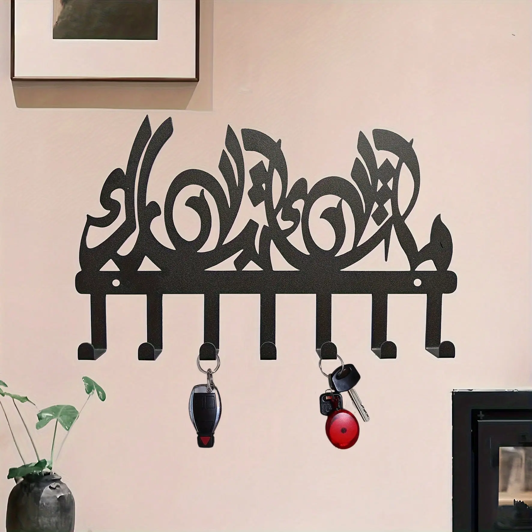 This premium metal key hook, adorned with classic Islamic calligraphy, features an elegant and vintage Arabic-style design combined with artistic patterns and multiple hooks, making it perfect for hanging keys, hats, bags, and other items.
