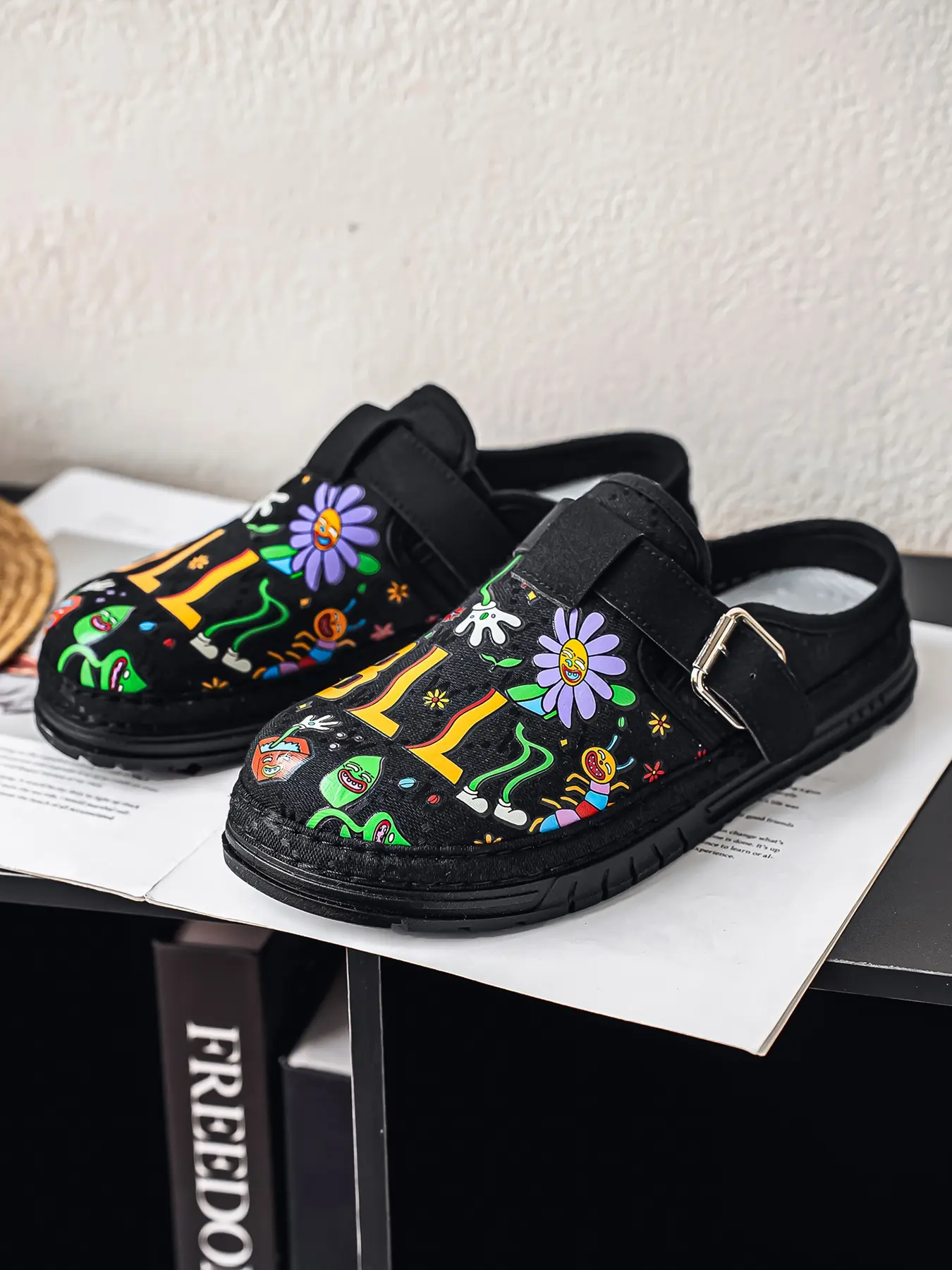 Street-style unisex half slides with graffiti. Leather and fabric combined upper, adjustable buckle and non-slip thick PVC sole for multi-scene use.