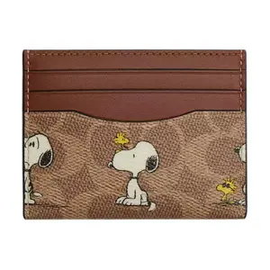 COACH x PEANUTS Slim 10 Cardholder – Unisex Cartoon Print Coated Canvas and Leather Wallet in Brown