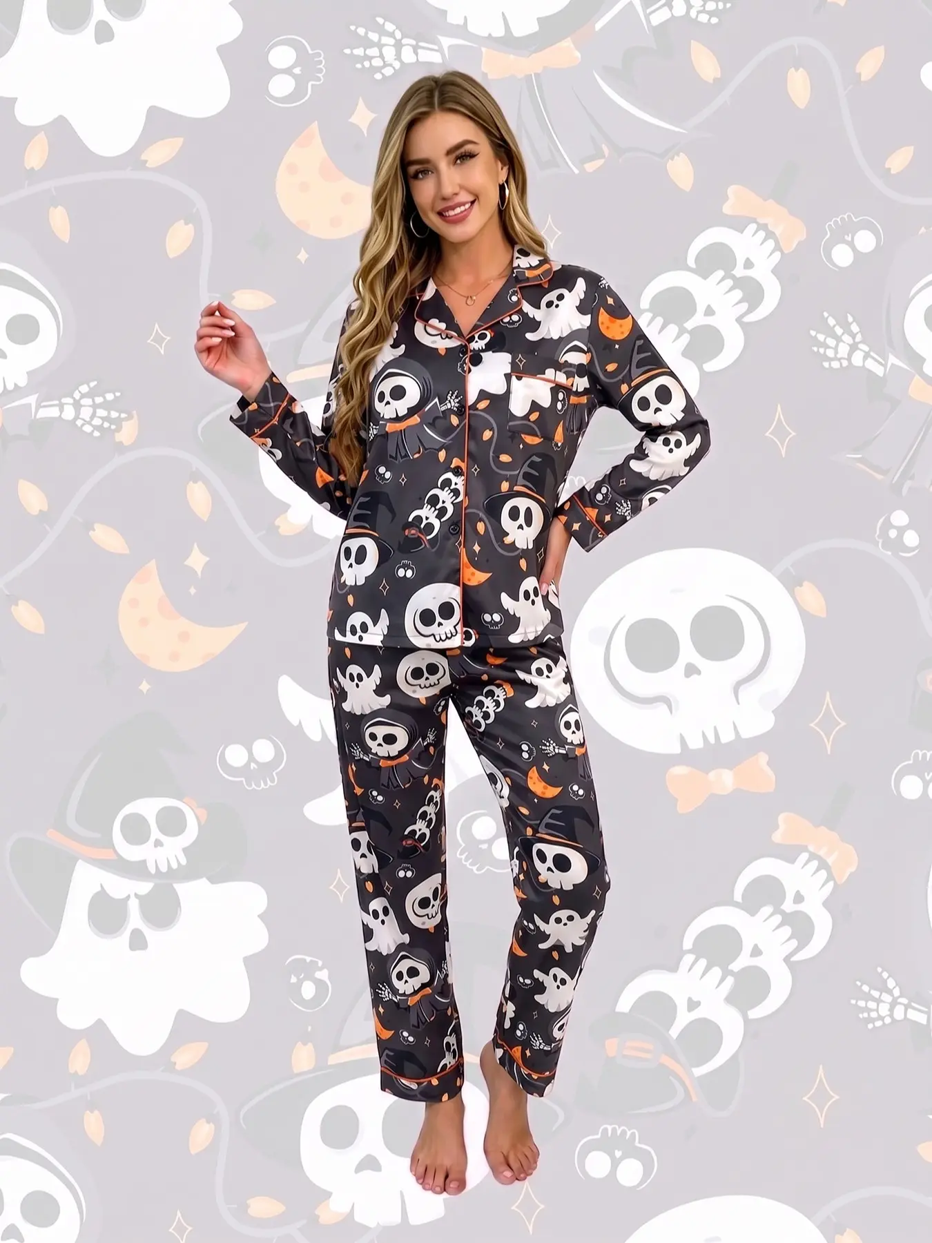 Women's 2-piece pajama set, black Halloween skull & ghost prints. Cartoon skulls, cute ghosts, crescent moons, stars and skeleton hands. Trendy cartoon style. Orange trim, lapel top with pocket, elastic waist long pants, soft comfy women's loungewear