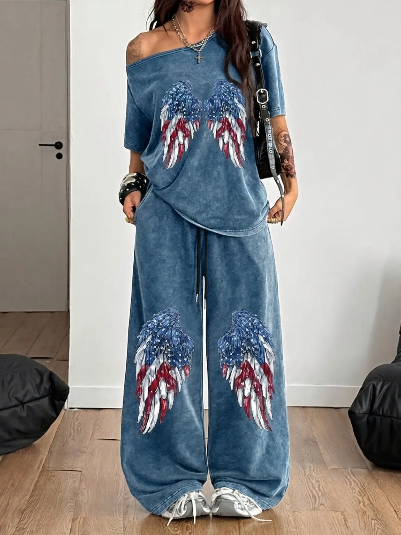 Off-shoulder short-sleeved top + drawstring wide-leg pants with a retro washed finish and star-spangled wing print. The loose fit is flattering for all body types. Accessorize as you like with any shoes. Casual