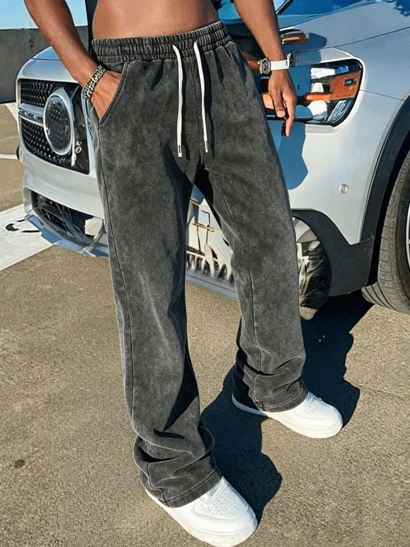 Men's sweatpants featuring a distressed wash finish and cotton fabric; designed with a slight flare and a distinctive streetwear aesthetic, making them a versatile staple for everyday wear. Drawstring Waist Sweatpants