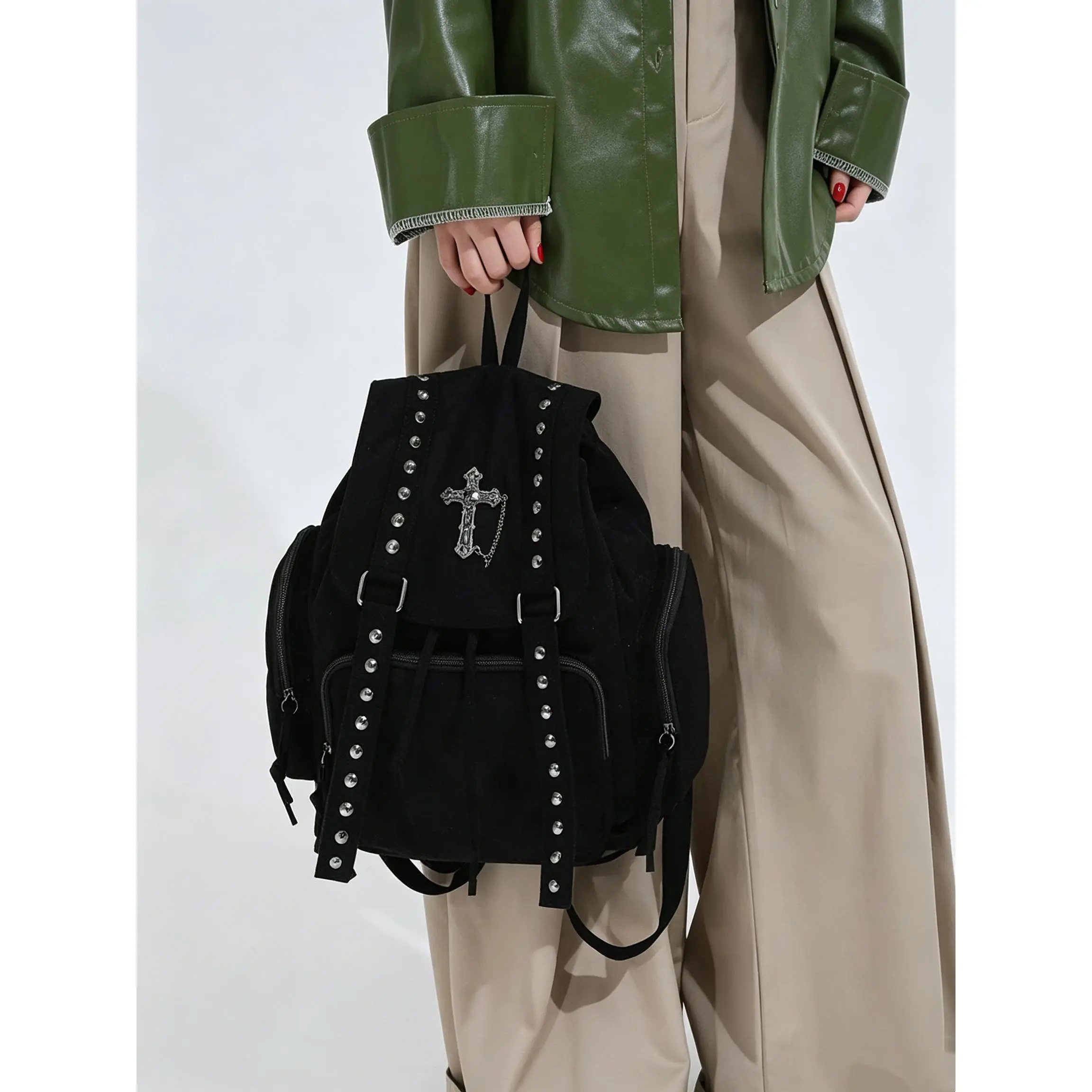 Black Studded Backpack with Ornate Metal Cross Charm, Flap and Drawstring Closure, Gothic-Inspired Rucksack with Front Pocket and Top Handle for Streetwear Outfits, Daily Errands and Weekend Trips