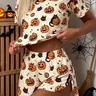 Halloween Summer's 2-Piece Set with Pumpkin Ghost Print: Casual Loose Knit Short-Sleeve Top with Midriff Reveal and Side-Slit Shorts; Stylish Aesthetic loungewear, suitable for everyday wear, parties, and other occasions.
