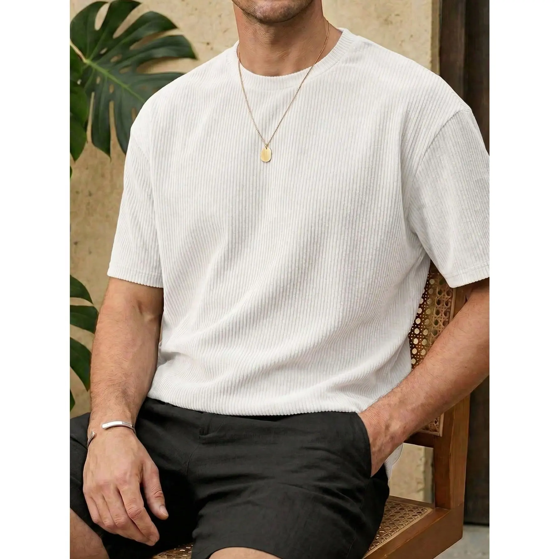 Crew neck short sleeve textured knit tee with vertical ribbed fabric, relaxed casual fit and soft breathable material. Simple minimalist silhouette creates trendy versatile daily outfits for contemporary mensfashion.