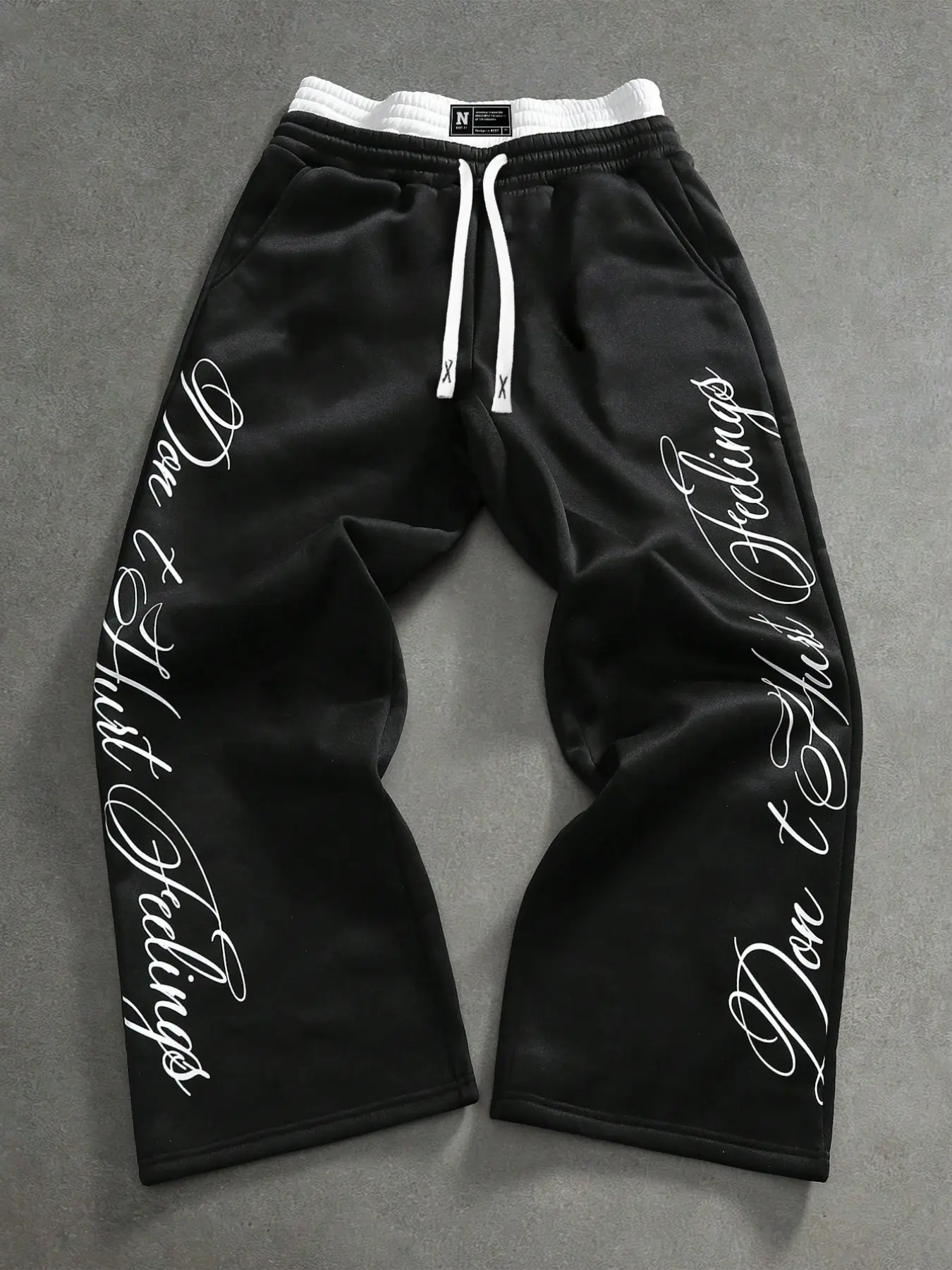 Cozy Oversized Black Wide Leg Joggers Featuring "Don't Hurt Feelings" Script Print & Contrast Drawstrings | High Street Casual Sweatpants for Skate & Loungewear