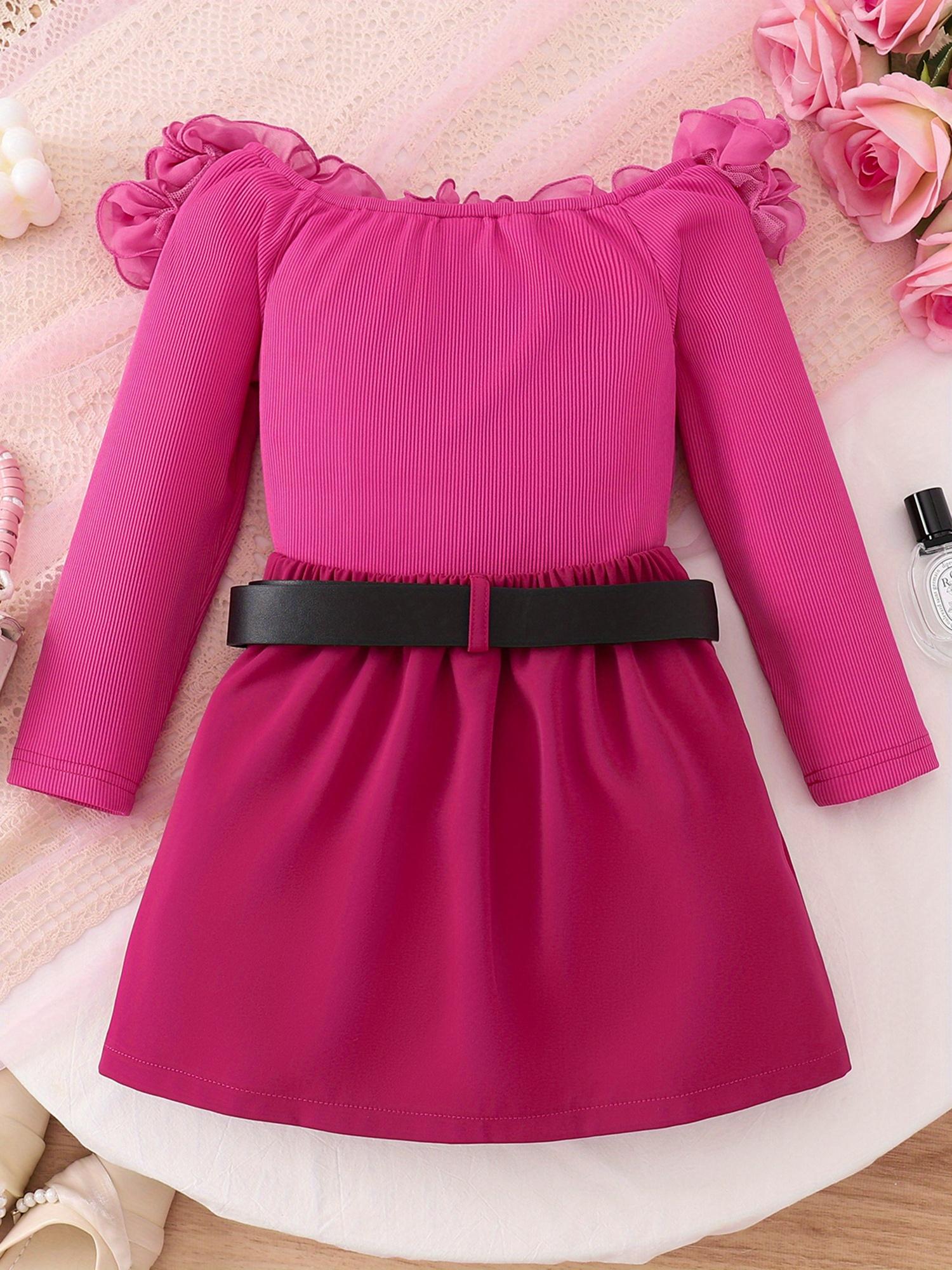 Girls' Dress, The Main Body Is Rose Red, The Shoulders Are Decorated with Flower-Like Folds, And The Long-Sleeved Design. with a Black Belt, There Are Golden Letters in The Middle of The Belt, And The Skirt Is Pleated. The Overall Style Is Sweet And Fa