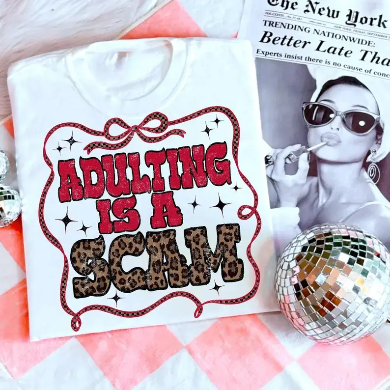 Unisex Oversized Cotton Round Neck T-Shirt - "Adulting Is a Scam" Printed, Everyday Casual Trendy Checkered Western Apparel Top with Adult Mental Health Humor, Leopard Print Gift, Fast Shipping
