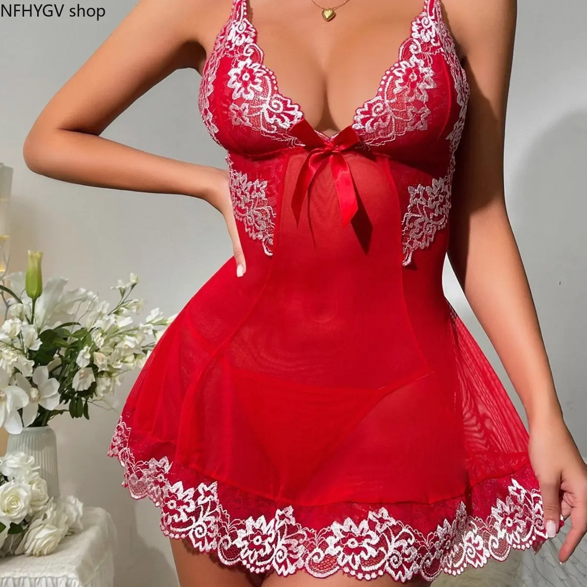 Women’s sheer mesh babydoll sleep chemise with contrast lace details. Features red V neck, spaghetti straps, white floral lace edging and elegant satin bow. Flowy mini lingerie dress, perfect romantic sleepwear for indoor evening lounge.