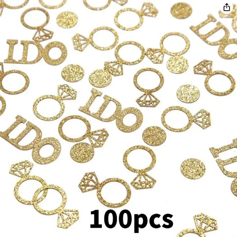 The wedding party was decorated with colorful confetti. At the engagement table, golden glittering rings and wedding IDO letters were scattered with confetti.