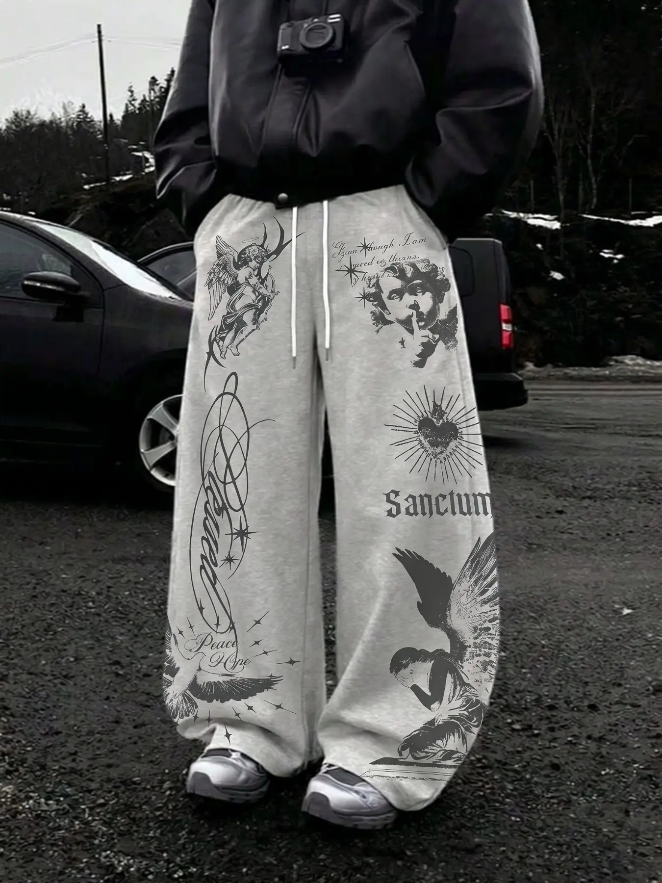 Retro hip-hop grunge wide-leg sweatpants in heather gray, unisex, Adjustable, loose drawstring jogger full-length trousers. Features gothic angel, cupid, sacred heart, praying maiden, star and vintage cursive "Sanctum" prints along full side seams