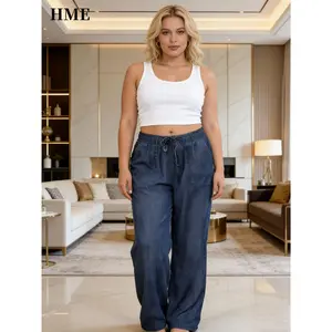 [] New Arrival Women's Denim Overalls. Elastic Waist with Drawstring, Loose Leg Design, Two Large Front Pockets. Straps Cross Diagonally From Shoulders to Waist.