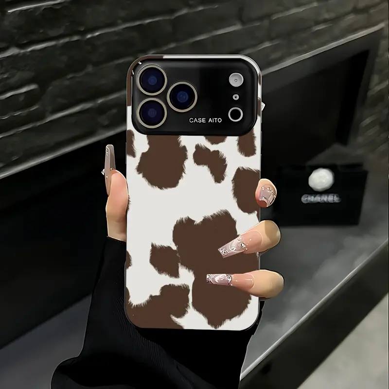 Large, dark brown cow-striped pattern phone case. Compatible with iPhone 17 Pro Max, 16 Pro Max, 15 Pro Max, and 14 Pro Max. Full lens protection. Also compatible with iPhone 15, 14, 13, and 12. Made of skin-friendly TPU material.