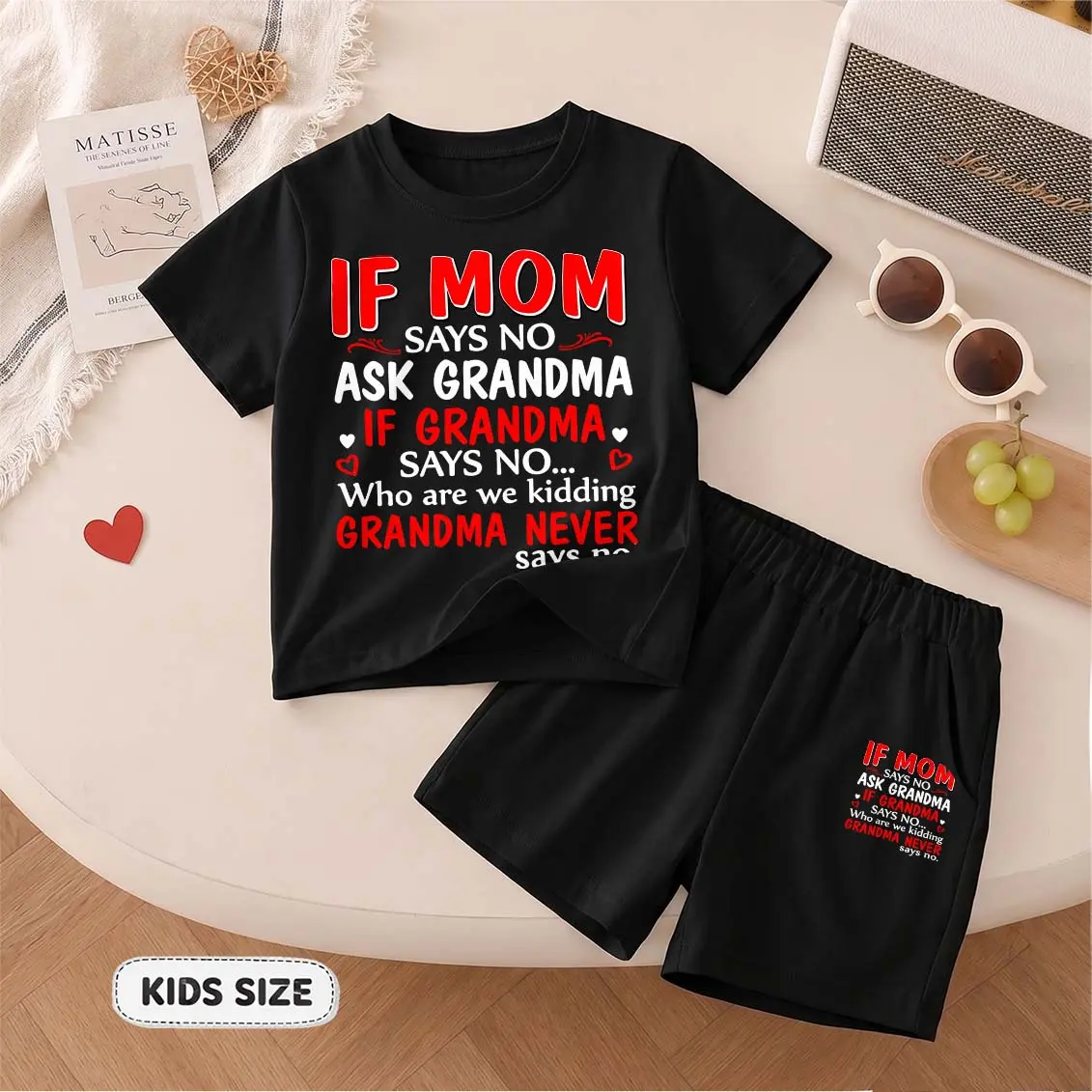 Kids’ “If Mom Says No Ask Grandma” Cartoon Print Short-Sleeve T-Shirt And Shorts Set—Casual Summer Kids' Clothing. This Round-Neck Outfit Combination Is Perfect For Everyday Wear And Outdoor Play.