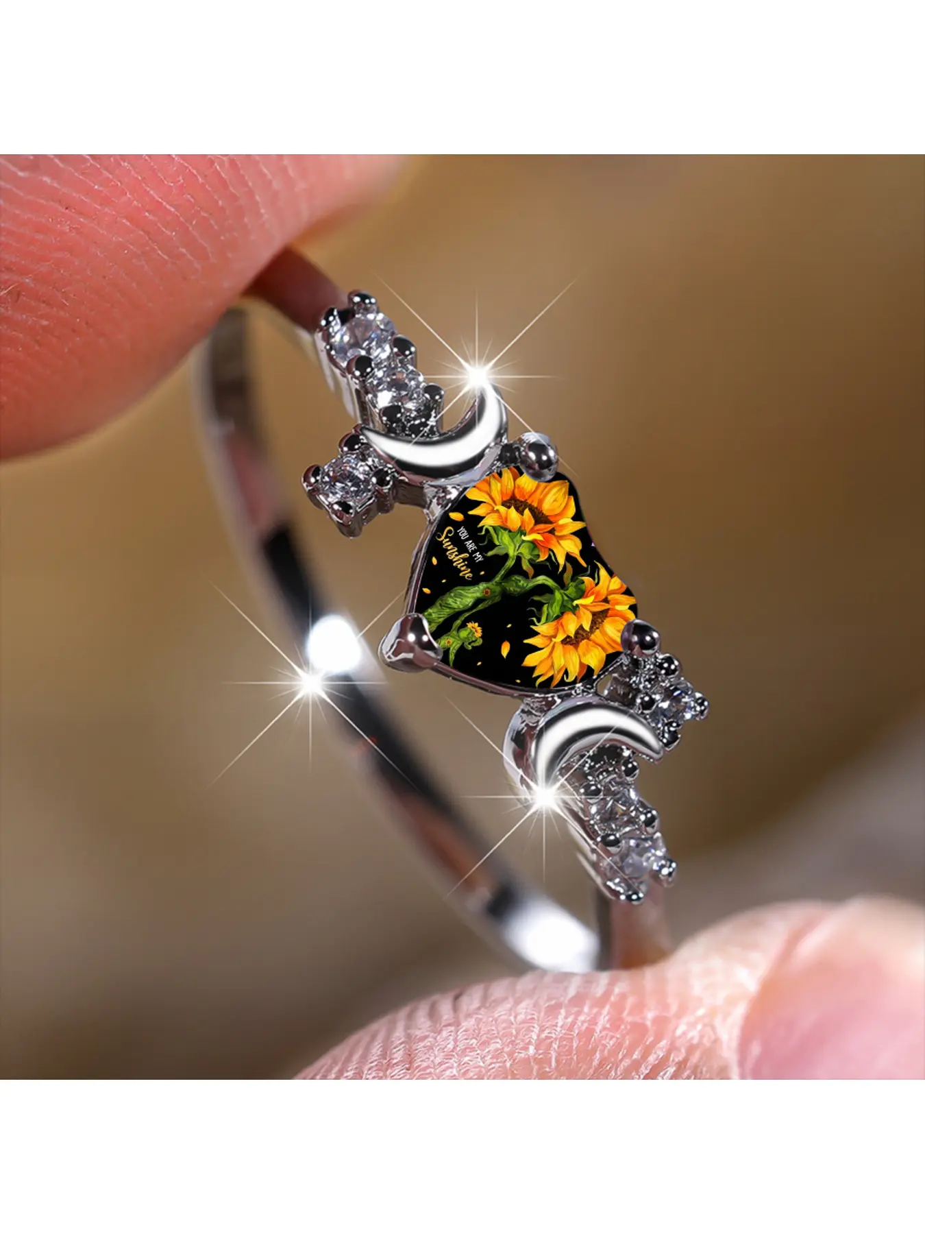 Sunflower slogan moon-shaped diamond silver ring, black background heart-shaped embellishment featuring two sunflowers facing upward, printed with warm-hearted English phrases. Up and down moon shapes are surrounded by shiny zirconium stones. An energetic