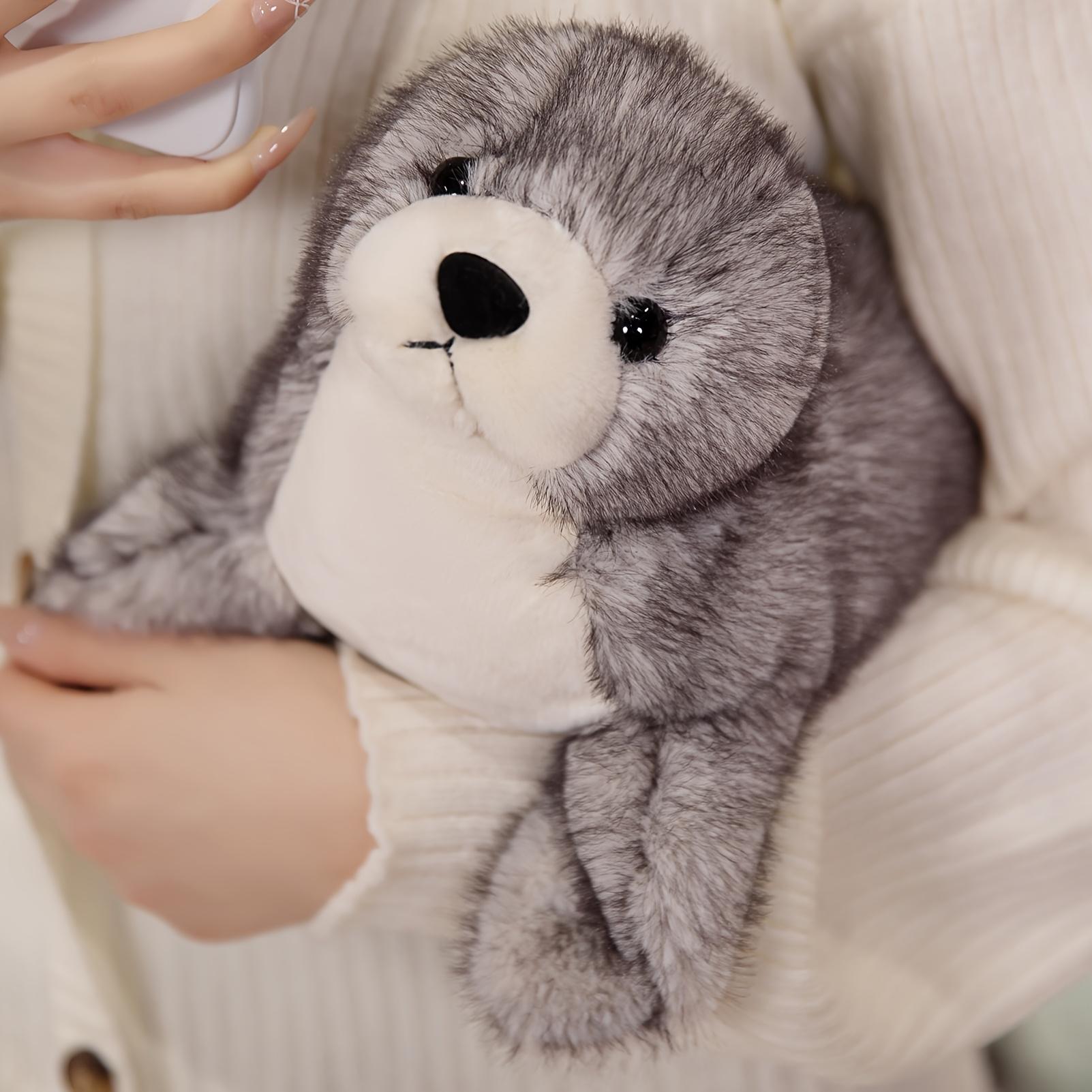 Adorable plush sea lion toy, super soft stuffed animal in a lazy pose, with silky fins suitable for cuddling and sensory play in the nursery