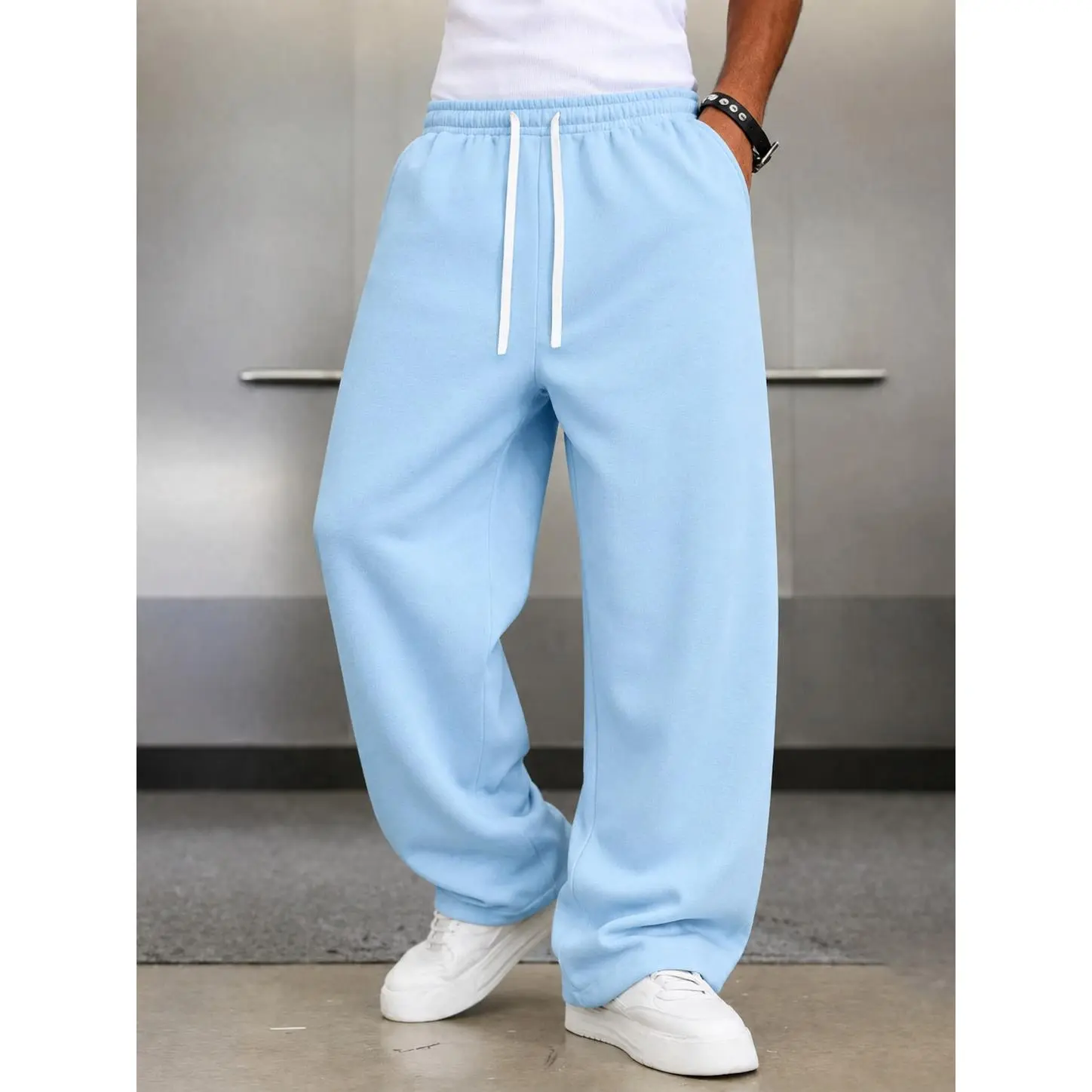 Soft cotton wide leg sweat pants with adjustable drawstring elastic waistband, loose flowing silhouette and side pockets, lightweight casual bottoms, trendy daily essential for versatile modern mensfashion styling.