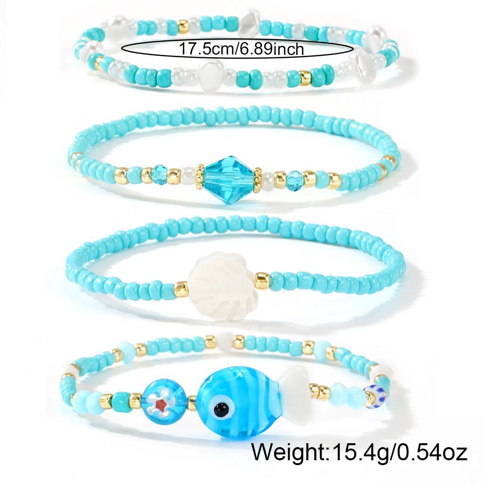 Niche & Whimsical Blue Glass Crystal Bracelet — Scallop Shell and Pearl-White Beaded Strand