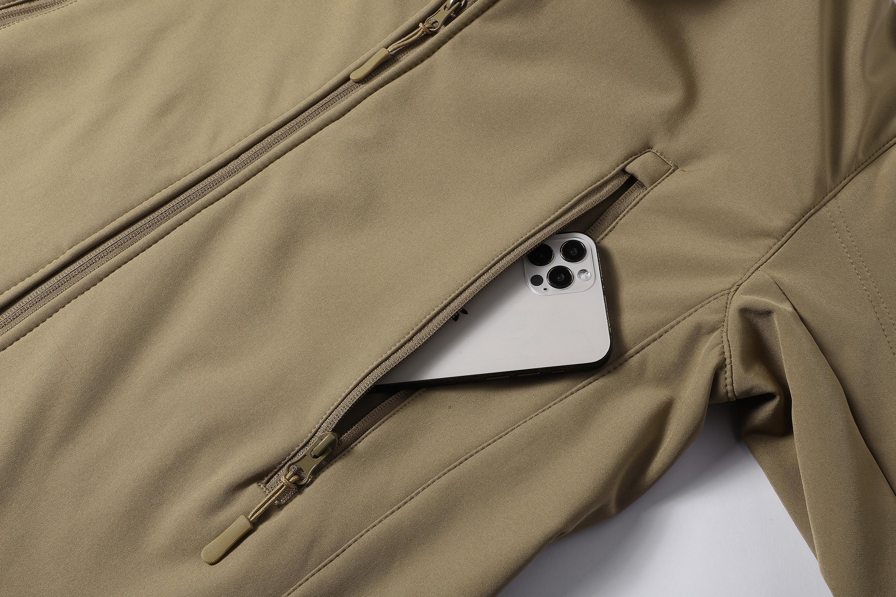 A men's hooded jacket with an outdoor and functional style features multiple zipper pockets distributed on the chest, arms, etc., making it convenient to store various small items and highly practical. Hood with drawstring closure