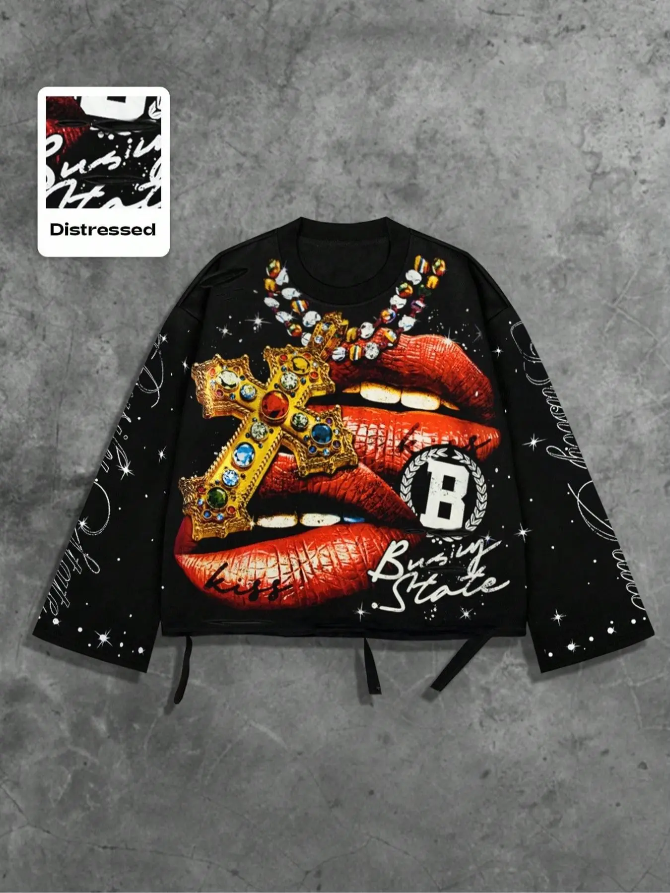 Unisex distressed streetwear Baggy long-sleeve crewneck T-shirt featuring a "red lips biting a jeweled cross" graphic, star-patterned sleeves, "Busy State" script slogan, a "B" badge, and a shredded hem; street-style Tops