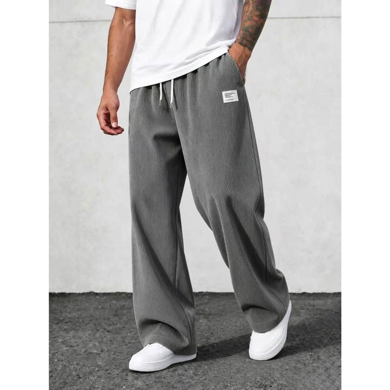 Retro corduroy casual pants with elastic drawstring waist, vertical ribbed textured fabric loose floor-length silhouette small label detail retro relaxed bottom staple for street modern mensfashion styling