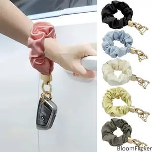 Soft fabric scrunchie‑style wrist keychain with a detachable metal ring. Lightweight portable wristlet strap works for car keys, water bottles and handbag pendants. Practical everyday‑carry decorative accessory tailored for women