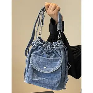 Retro distressed denim drawstring bucket messenger bag, Vintage bag, Casual Fashion Bag, Fashionable crossbody bag, front pocket metal buckle design, adjustable shoulder strap crossbody messenger bag, suitable for daily travel
