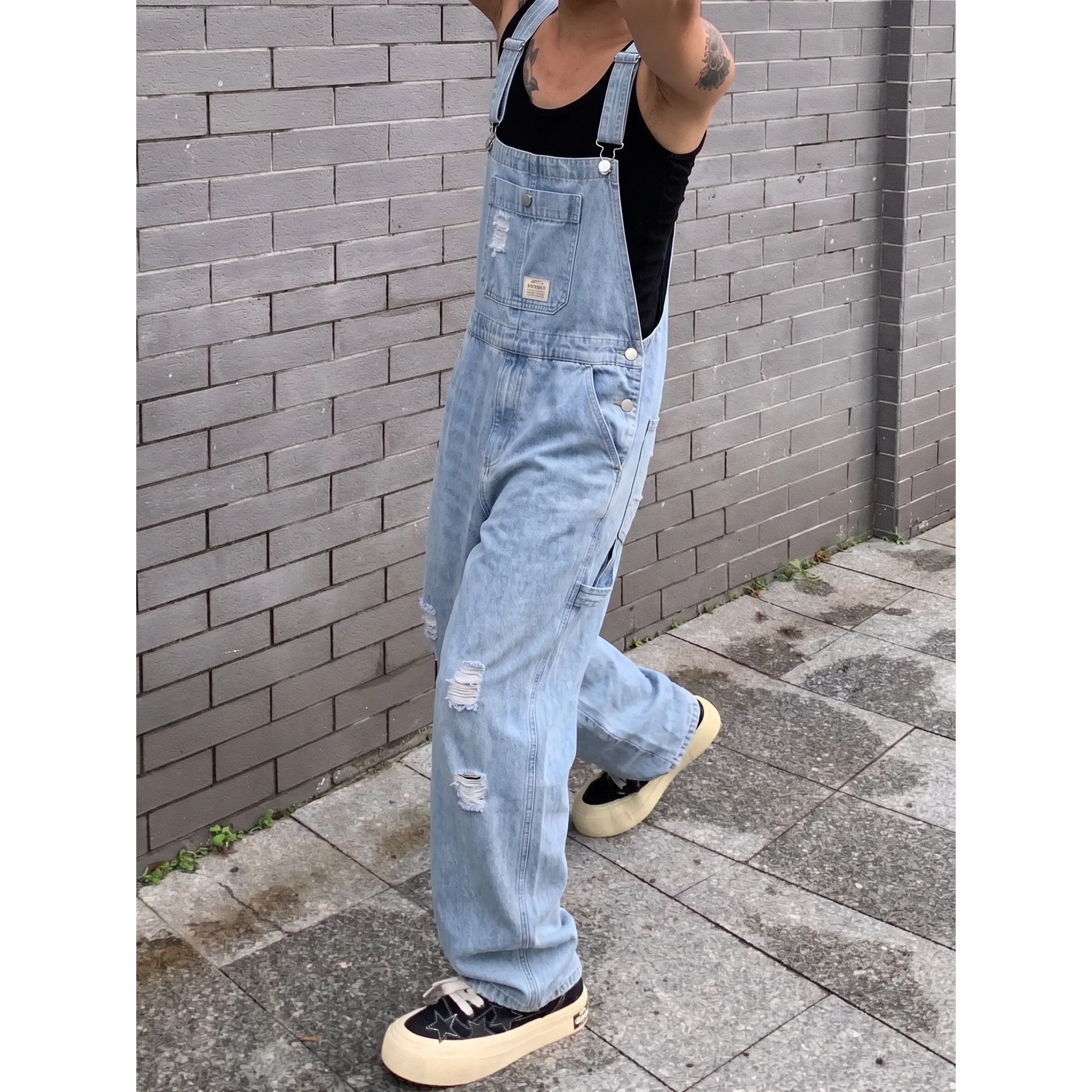 Vintage Pale Blue Multi-Rip Frayed Denim Bib Overalls For Males Adjustable Shoulder Slide Buckles Oversized Baggy Wide Leg Dungarees Y2K Skate Grunge Streetwear Relax Fit One Piece Jumpsuit For Summer Content Shooting Short Road Trips